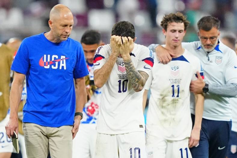 Dec 3, 2022; Al Rayyan, Qatar; United States of America manager Gregg Berhalter and forward Christian Pulisic (10) and midfielder Brenden Aaronson (11) react after losing a round of sixteen match against the Netherlands in the 2022 FIFA World Cup at Khalifa International Stadium. Mandatory Credit: Danielle Parhizkaran-USA TODAY Sports