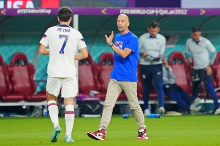 Dec 3, 2022; Al Rayyan, Qatar; United States of America manager Gregg Berhalter talks with midfielder Giovanni Reyna (7) against the Netherlands during the second half of a round of sixteen match in the 2022 FIFA World Cup at Khalifa International Stadium. Mandatory Credit: Danielle Parhizkaran-USA TODAY Sports