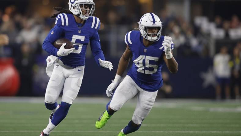 Dec 4, 2022; Arlington, Texas, USA;  Indianapolis Colts cornerback Stephon Gilmore (5) returns an interception as linebacker E.J. Speed (45) looks to make a block in the second quarter against the Dallas Cowboys at AT&T Stadium. Mandatory Credit: Tim Heitman-USA TODAY Sports