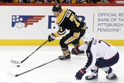 Dec 6, 2022; Pittsburgh, Pennsylvania, USA;  Pittsburgh Penguins center Evgeni Malkin (71) skates with the puck against Columbus Blue Jackets center Sean Kuraly (7) during the second period at PPG Paints Arena. Mandatory Credit: Charles LeClaire-USA TODAY Sports