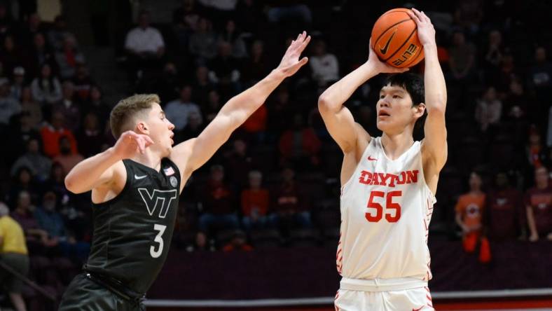 Dec 7, 2022; Blacksburg, Virginia, USA; Dayton Flyers forward Mike Sharavjamts (55) shoots over Virginia Tech Hokies guard Sean Pedulla (3) at Cassell Coliseum. Mandatory Credit: Lee Luther Jr.-USA TODAY Sports