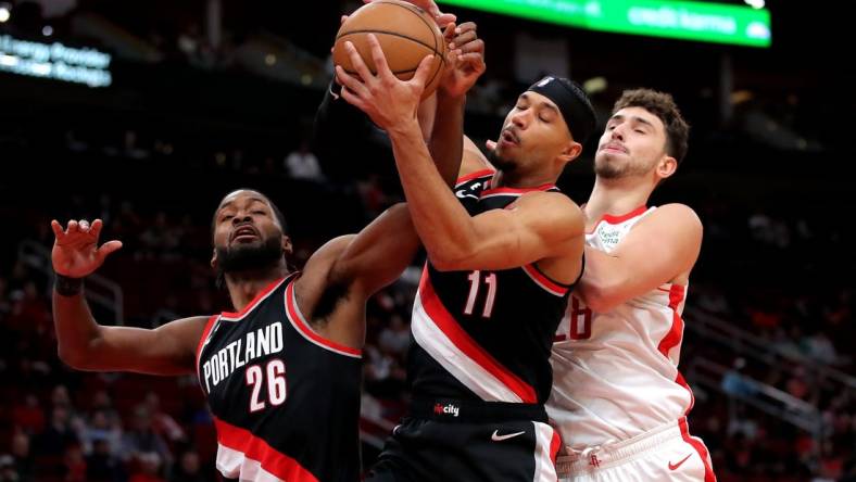 Dec 17, 2022; Houston, Texas, USA; From left, Portland Trail Blazers forward Justise Winslow (26), Portland Trail Blazers guard Josh Hart (11) and Houston Rockets center Alperen Sengun (28) battle for a rebound during the first quarter at Toyota Center. Mandatory Credit: Erik Williams-USA TODAY Sports