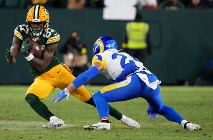Green Bay Packers wide receiver Romeo Doubs (87) picks up 21-yards on a reception before being tackled by Los Angeles Rams safety Taylor Rapp (24) during the fourth quarter of their game Monday, December 19, 2022 at Lambeau Field in Green Bay, Wis. The Green Bay Packers beat the Los Angeles Rams 24-12.

Packers19 1