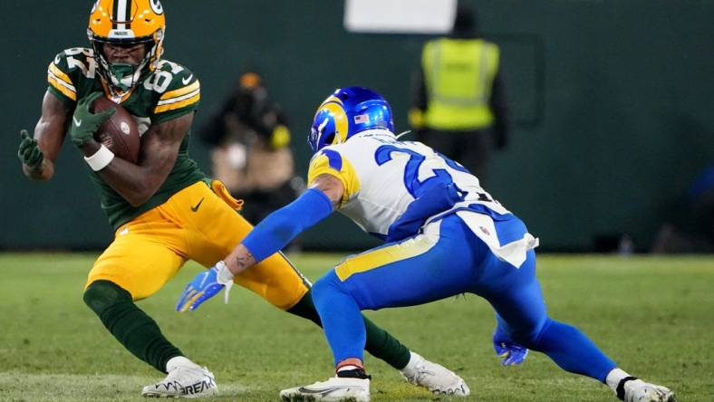 Green Bay Packers wide receiver Romeo Doubs (87) picks up 21-yards on a reception before being tackled by Los Angeles Rams safety Taylor Rapp (24) during the fourth quarter of their game Monday, December 19, 2022 at Lambeau Field in Green Bay, Wis. The Green Bay Packers beat the Los Angeles Rams 24-12.

Packers19 1