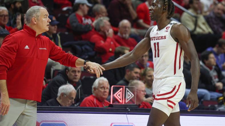 Dec 23, 2022; Piscataway, New Jersey, USA; Rutgers Scarlet Knights head coach Steve Pikiell greets center Clifford Omoruyi (11) after being subbed out during the second half against the Bucknell Bison at Jersey Mike's Arena. Mandatory Credit: Vincent Carchietta-USA TODAY Sports