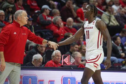 Dec 23, 2022; Piscataway, New Jersey, USA; Rutgers Scarlet Knights head coach Steve Pikiell greets center Clifford Omoruyi (11) after being subbed out during the second half against the Bucknell Bison at Jersey Mike's Arena. Mandatory Credit: Vincent Carchietta-USA TODAY Sports