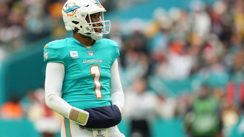 Dec 25, 2022; Miami Gardens, Florida, USA; Miami Dolphins quarterback Tua Tagovailoa (1) stands on the field during the second half against the Green Bay Packers at Hard Rock Stadium. Mandatory Credit: Jasen Vinlove-USA TODAY Sports