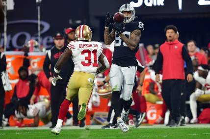 January 1, 2023; Paradise, Nevada, USA; Las Vegas Raiders tight end Darren Waller (83) catches a pass against San Francisco 49ers safety Tashaun Gipson Sr. (31) during the second half at Allegiant Stadium. Mandatory Credit: Gary A. Vasquez-USA TODAY Sports