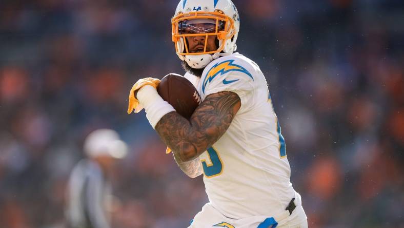 Jan 8, 2023; Denver, Colorado, USA; Los Angeles Chargers wide receiver Keenan Allen (13) catches the ball and runs for a touchdown in the first quarter against the Denver Broncos at Empower Field at Mile High. Mandatory Credit: Isaiah J. Downing-USA TODAY Sports