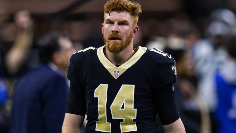 Jan 8, 2023; New Orleans, Louisiana, USA;  New Orleans Saints quarterback Andy Dalton (14) runs to the locker room after the game against the Carolina Panthers during the second half at Caesars Superdome. Mandatory Credit: Stephen Lew-USA TODAY Sports