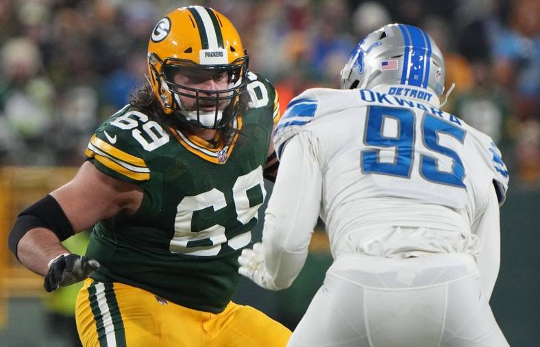 Jan 8, 2023; Green Bay, Wisconsin, USA; Green Bay Packers offensive tackle David Bakhtiari (69) provides pass protection while covering Detroit Lions linebacker Romeo Okwara (95) during the second quarter at Lambeau Field. Mandatory Credit: Mark Hoffman/Milwaukee Journal Sentinel via USA TODAY NETWORK
