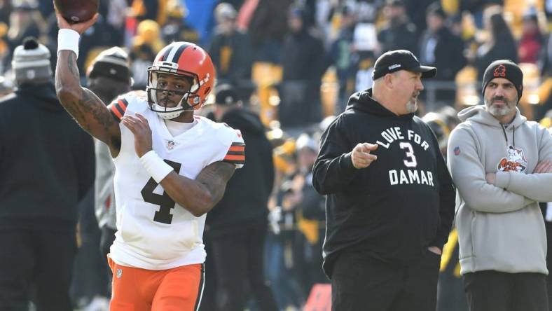 Jan 8, 2023; Pittsburgh, Pennsylvania, USA;  Cleveland Browns quarterback Deshaun Watson (4) throws a practice pass as head coach Kevin Stefanski (right) watches before playing the Pittsburgh Steelers at Acrisure Stadium. Mandatory Credit: Philip G. Pavely-USA TODAY Sports