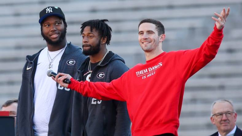 Jan 14, 2023; Athens, GA, USA; Georgia Bulldogs offensive lineman Sedrick Van Pran (63) and defensive back Christopher Smith (29) and quarterback Stetson Bennett (13) speak at the national championship celebration at Sanford Stadium. Mandatory Credit: Brett Davis-USA TODAY Sports