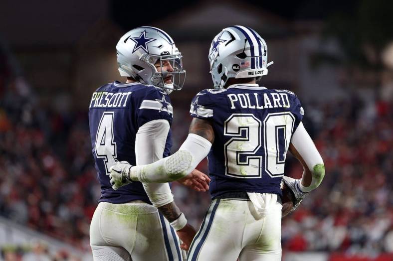 Jan 16, 2023; Tampa, Florida, USA; Dallas Cowboys running back Tony Pollard (20) reacts with quarterback Dak Prescott (4) after a touchdown against the Tampa Bay Buccaneers in the first half during the wild card game at Raymond James Stadium. Mandatory Credit: Nathan Ray Seebeck-USA TODAY Sports