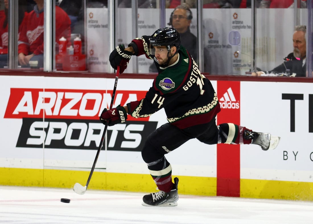 Jan 17, 2023; Tempe, Arizona, USA; Arizona Coyotes defenseman Shayne Gostisbehere (14) passes the puck against the Detroit Red Wings in the first period at Mullett Arena. Mandatory Credit: Mark J. Rebilas-USA TODAY Sports