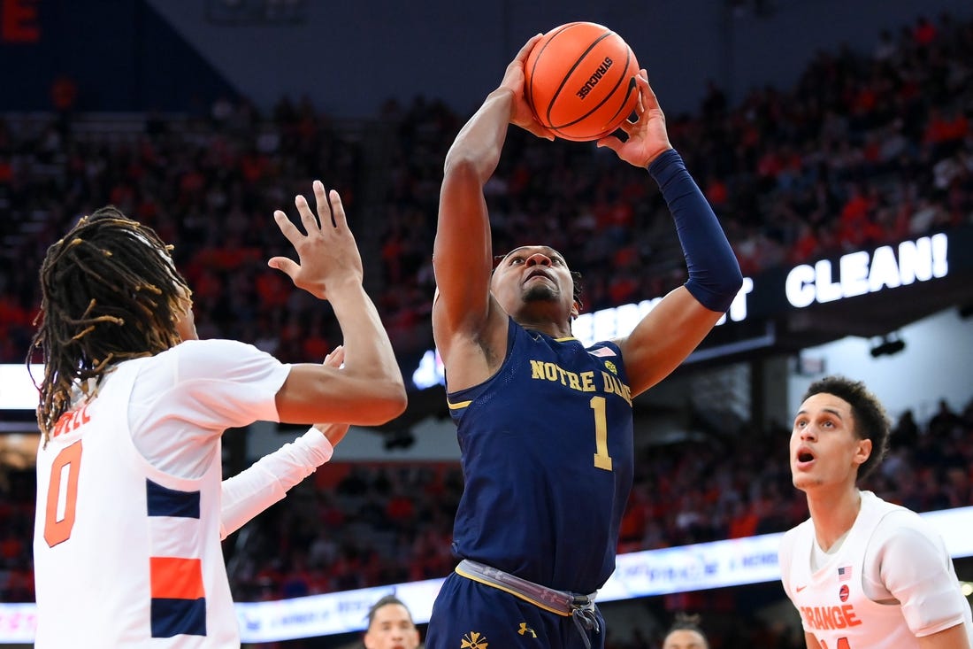 Jan 14, 2023; Syracuse, New York, USA; Notre Dame Fighting Irish guard J.J. Starling (1) drives to the basket between Syracuse Orange forward Chris Bell (0) and center Jesse Edwards (right) during the second half at the JMA Wireless Dome. Mandatory Credit: Rich Barnes-USA TODAY Sports