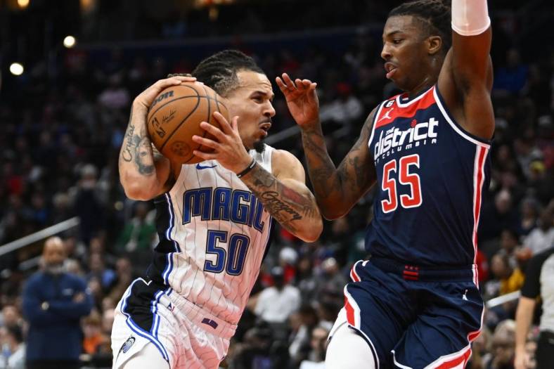 Jan 21, 2023; Washington, District of Columbia, USA; Orlando Magic guard Cole Anthony (50) drives against Washington Wizards guard Delon Wright (55) during the first half at Capital One Arena. Mandatory Credit: Brad Mills-USA TODAY Sports