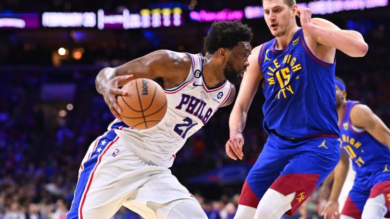 Jan 28, 2023; Philadelphia, Pennsylvania, USA; Philadelphia 76ers center Joel Embiid (21) drives against Denver Nuggets center Nikola Jokic (15) in the third quarter at Wells Fargo Center. Mandatory Credit: Kyle Ross-USA TODAY Sports