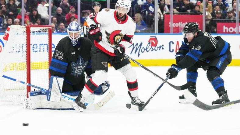 Jan 27, 2023; Toronto, Ontario, CAN; Ottawa Senators center Derick Brassard (61) battles for the puck with Toronto Maple Leafs defenseman Morgan Rielly (44) in front of Toronto Maple Leafs goaltender Ilya Samsonov (35) during the second period at Scotiabank Arena. Mandatory Credit: Nick Turchiaro-USA TODAY Sports