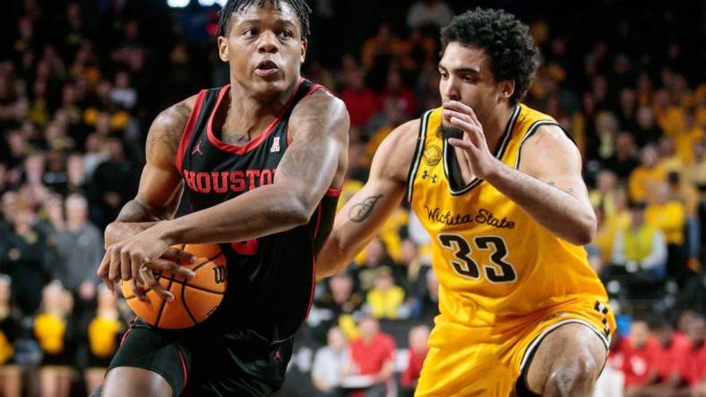 Jan 25, 2023; Wichita, Kansas, USA; Houston Cougars guard Marcus Sasser (0) drives around Wichita State Shockers forward James Rojas (33) during the first half at Charles Koch Arena. Mandatory Credit: William Purnell-USA TODAY Sports