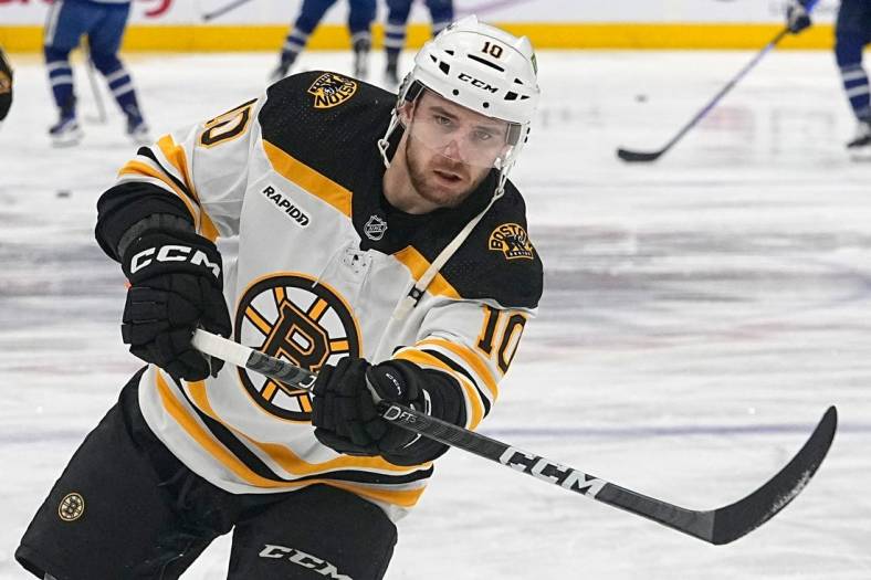 Feb 1, 2023; Toronto, Ontario, CAN; Boston Bruins forward A.J. Greer (10) shoots the puck during warm up before a game against the Toronto Maple Leafs  at Scotiabank Arena. Mandatory Credit: John E. Sokolowski-USA TODAY Sports