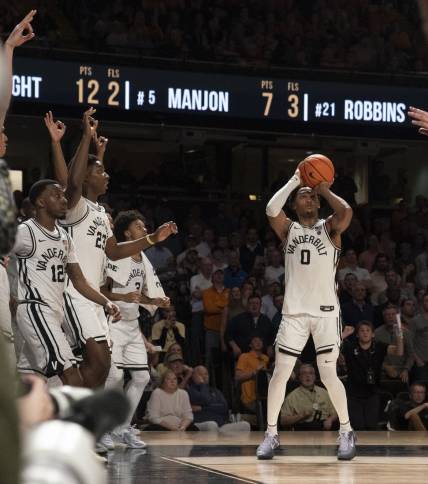 Feb 8, 2023; Nashville, Tennessee, USA;   Vanderbilt Commodores guard Tyrin Lawrence (0) shoots a three point basket at the buzzer to defeat the Tennessee Volunteers 66 to 65 at Memorial Gymnasium.  Mandatory Credit: George Walker IV - USA TODAY Sports