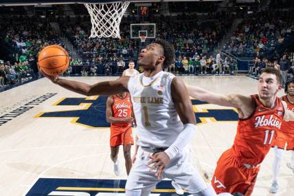 Feb 11, 2023; South Bend, Indiana, USA; Notre Dame Fighting Irish guard JJ Starling (1) goes up for a shot as Virginia Tech Hokies forward John Camden (11) defends in the first half at the Purcell Pavilion. Mandatory Credit: Matt Cashore-USA TODAY Sports