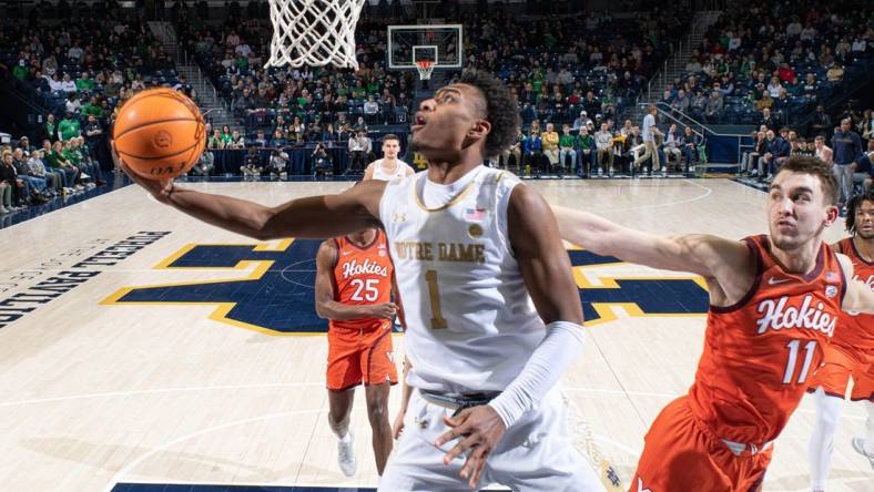 Feb 11, 2023; South Bend, Indiana, USA; Notre Dame Fighting Irish guard JJ Starling (1) goes up for a shot as Virginia Tech Hokies forward John Camden (11) defends in the first half at the Purcell Pavilion. Mandatory Credit: Matt Cashore-USA TODAY Sports