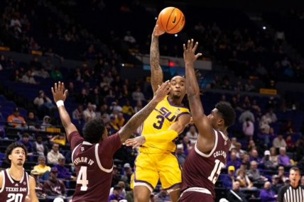 Feb 11, 2023; Baton Rouge, Louisiana, USA;  LSU Tigers guard Justice Hill (3) passes the ball against Texas A&M Aggies forward Henry Coleman III (15) and guard Erik Pratt (3) during the first half at Pete Maravich Assembly Center. Mandatory Credit: Stephen Lew-USA TODAY Sports