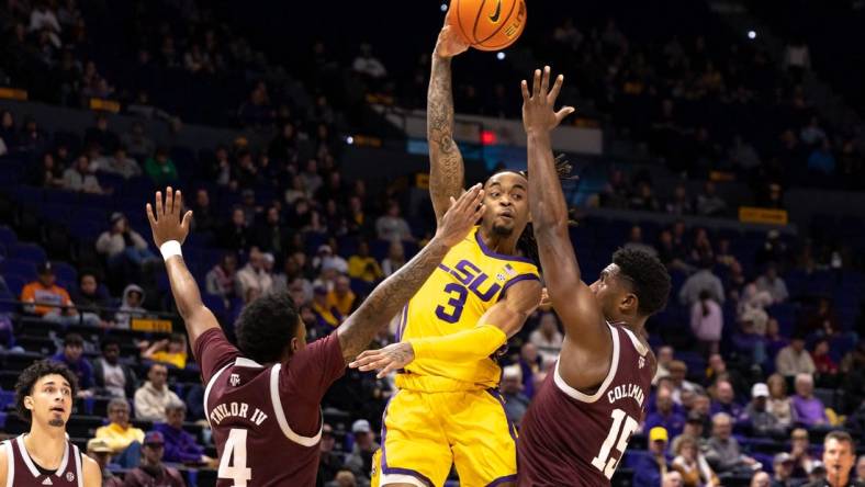 Feb 11, 2023; Baton Rouge, Louisiana, USA;  LSU Tigers guard Justice Hill (3) passes the ball against Texas A&M Aggies forward Henry Coleman III (15) and guard Erik Pratt (3) during the first half at Pete Maravich Assembly Center. Mandatory Credit: Stephen Lew-USA TODAY Sports