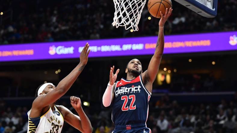 Feb 11, 2023; Washington, District of Columbia, USA; Washington Wizards guard Monte Morris (22) shoots as Indiana Pacers center Myles Turner (33) looks on during the second half at Capital One Arena. Mandatory Credit: Brad Mills-USA TODAY Sports