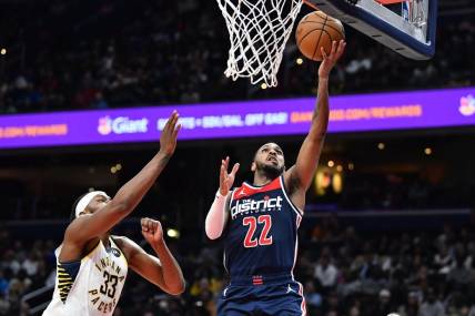 Feb 11, 2023; Washington, District of Columbia, USA; Washington Wizards guard Monte Morris (22) shoots as Indiana Pacers center Myles Turner (33) looks on during the second half at Capital One Arena. Mandatory Credit: Brad Mills-USA TODAY Sports