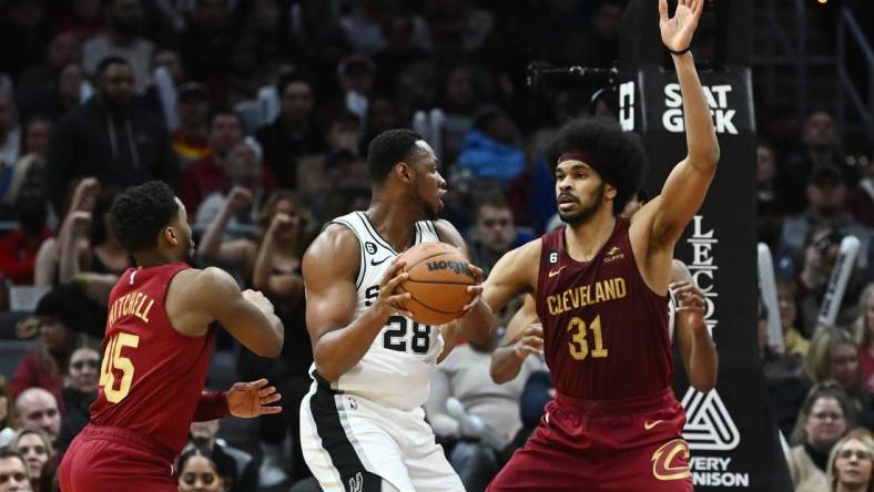 Feb 13, 2023; Cleveland, Ohio, USA; Cleveland Cavaliers center Jarrett Allen (31) and guard Donovan Mitchell (45) defend against San Antonio Spurs center Charles Bassey (28) during the second half at Rocket Mortgage FieldHouse. Mandatory Credit: Ken Blaze-USA TODAY Sports