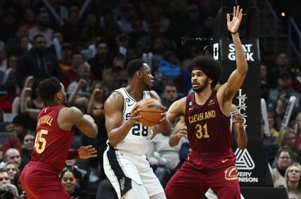 Feb 13, 2023; Cleveland, Ohio, USA; Cleveland Cavaliers center Jarrett Allen (31) and guard Donovan Mitchell (45) defend against San Antonio Spurs center Charles Bassey (28) during the second half at Rocket Mortgage FieldHouse. Mandatory Credit: Ken Blaze-USA TODAY Sports