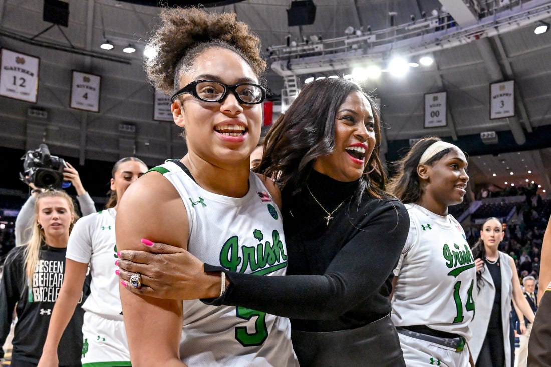 Feb 16, 2023; South Bend, Indiana, USA; Notre Dame Fighting Irish head coach Niele Ivey and guard Olivia Miles (5) leave the court after Notre Dame defeated the Louisville Cardinals 78-76 in overtime. Mandatory Credit: Matt Cashore-USA TODAY Sports