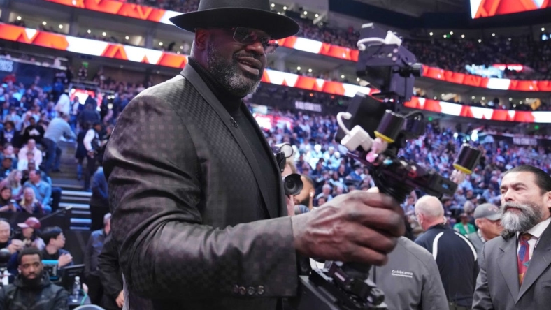 Feb 18, 2023; Salt Lake City, UT, USA; Shaquille O'Neal films himself with a camera during the 2023 All Star Saturday Night at Vivint Arena. Mandatory Credit: Kyle Terada-USA TODAY Sports