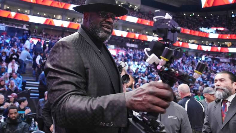 Feb 18, 2023; Salt Lake City, UT, USA; Shaquille O'Neal films himself with a camera during the 2023 All Star Saturday Night at Vivint Arena. Mandatory Credit: Kyle Terada-USA TODAY Sports