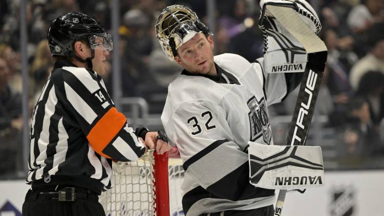 Feb 18, 2023; Los Angeles, California, USA;  Los Angeles Kings goaltender Jonathan Quick (32) talks with referee Trevor Hanson (14) during a stoppage in play against the Arizona Coyotes at Crypto.com Arena. Mandatory Credit: Jayne Kamin-Oncea-USA TODAY Sports