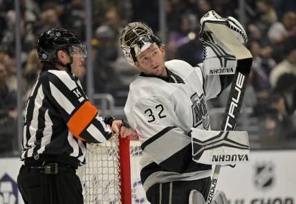 Feb 18, 2023; Los Angeles, California, USA;  Los Angeles Kings goaltender Jonathan Quick (32) talks with referee Trevor Hanson (14) during a stoppage in play against the Arizona Coyotes at Crypto.com Arena. Mandatory Credit: Jayne Kamin-Oncea-USA TODAY Sports