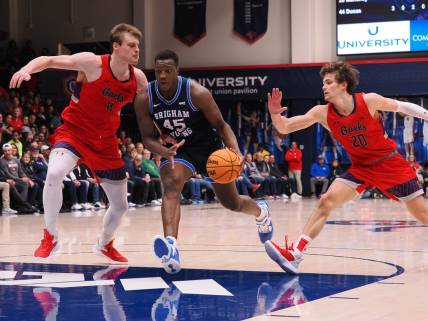 Feb 18, 2023; Moraga, California, USA; BYU Cougars forward Fouseeyni Traore (45) drives in against St. Mary's Gaels center Mitchell Saxen (11) and guard Aidan Mahaney (20) during the second half at University Credit Union Pavilion. Mandatory Credit: Kelley L Cox-USA TODAY Sports