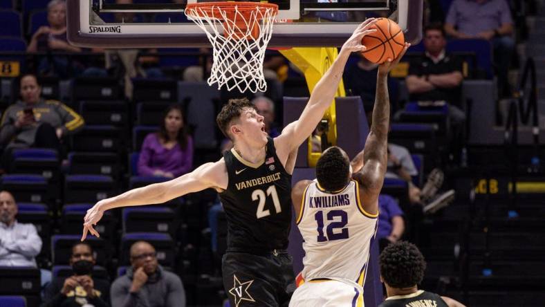 Feb 22, 2023; Baton Rouge, Louisiana, USA; Vanderbilt Commodores forward Liam Robbins (21) blocks the shot of LSU Tigers forward KJ Williams (12) during the second half at Pete Maravich Assembly Center. Mandatory Credit: Stephen Lew-USA TODAY Sports