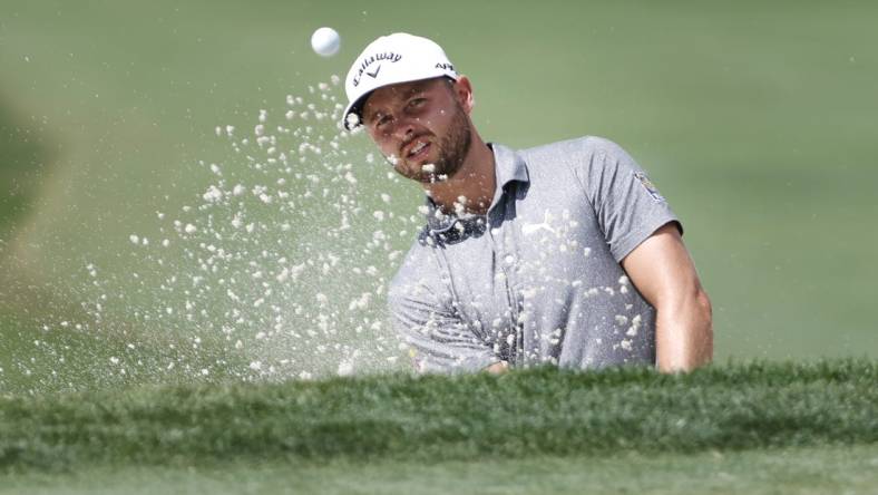 Feb 23, 2023; Palm Beach Gardens, Florida, USA; Adam Svensson plays a shot from a bunker on the third hole during the first round of the Honda Classic golf tournament. Mandatory Credit: Sam Navarro-USA TODAY Sports