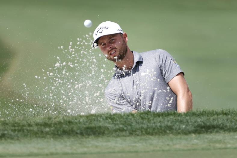 Feb 23, 2023; Palm Beach Gardens, Florida, USA; Adam Svensson plays a shot from a bunker on the third hole during the first round of the Honda Classic golf tournament. Mandatory Credit: Sam Navarro-USA TODAY Sports
