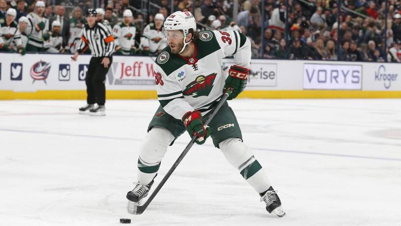 Feb 23, 2023; Columbus, Ohio, USA; Minnesota Wild right wing Ryan Hartman (38) passes the puck against the Columbus Blue Jackets during the first period at Nationwide Arena. Mandatory Credit: Russell LaBounty-USA TODAY Sports