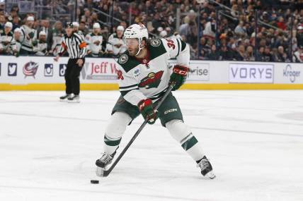 Feb 23, 2023; Columbus, Ohio, USA; Minnesota Wild right wing Ryan Hartman (38) passes the puck against the Columbus Blue Jackets during the first period at Nationwide Arena. Mandatory Credit: Russell LaBounty-USA TODAY Sports