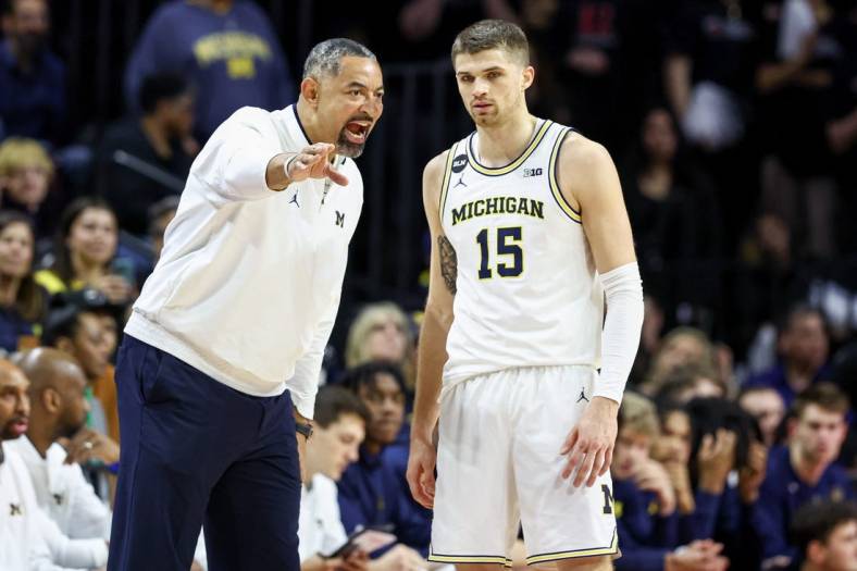 Feb 23, 2023; Piscataway, New Jersey, USA; Michigan Wolverines head coach Juwan Howard talks with guard Joey Baker (15) during the first half against the Rutgers Scarlet Knights at Jersey Mike's Arena. Mandatory Credit: Vincent Carchietta-USA TODAY Sports