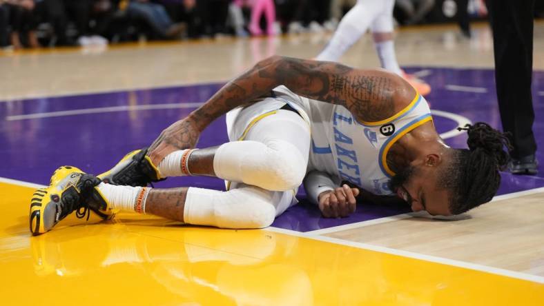 Feb 23, 2023; Los Angeles, California, USA; Los Angeles Lakers guard D'Angelo Russell (1) reacts after suffering a right ankle sprain after the game in the first half at Crypto.com Arena. Mandatory Credit: Kirby Lee-USA TODAY Sports