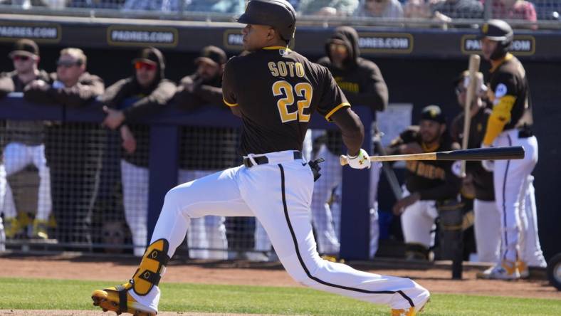 Feb 24, 2023; Peoria, Arizona, USA; San Diego Padres right fielder Juan Soto (22) hits a single against the Seattle Mariners in the first inning at Peoria Sports Complex. Mandatory Credit: Rick Scuteri-USA TODAY Sports