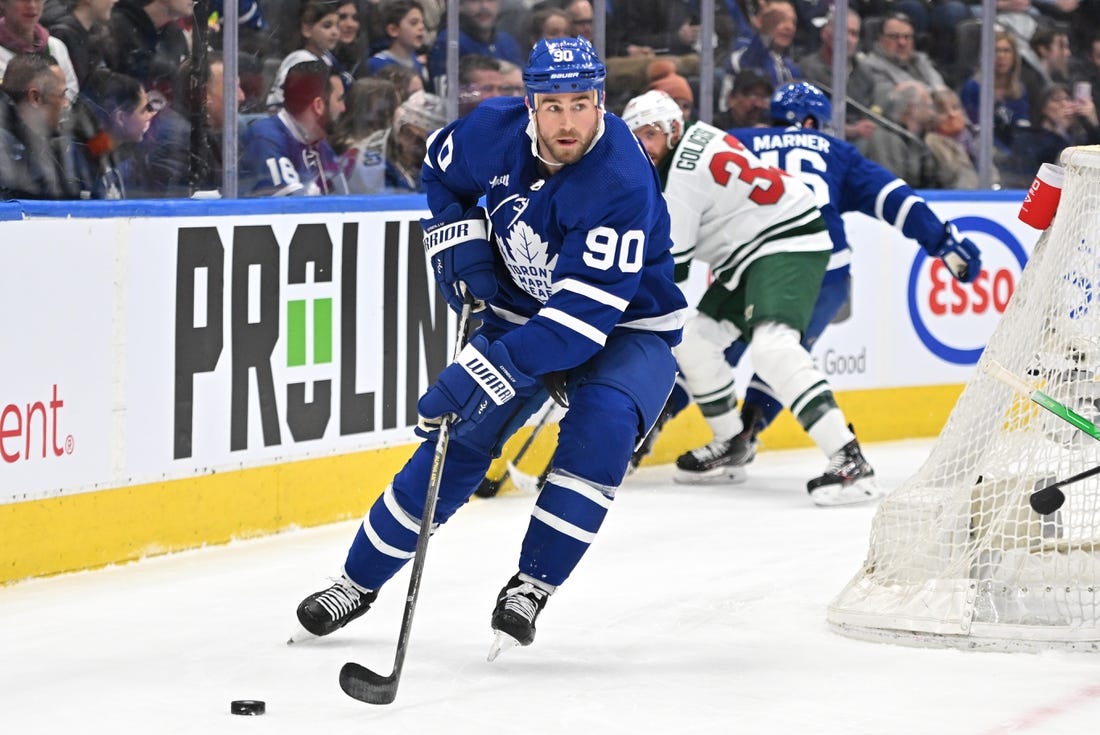 Feb 24, 2023; Toronto, Ontario, CAN;   Toronto Maple Leafs forward Ryan O'Reilly (90) looks to make a pass against the Minnesota Wild in the first period at Scotiabank Arena. Mandatory Credit: Dan Hamilton-USA TODAY Sports