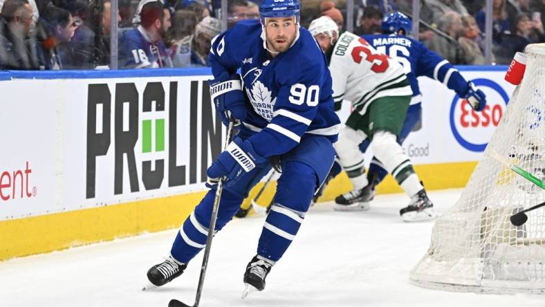 Feb 24, 2023; Toronto, Ontario, CAN;   Toronto Maple Leafs forward Ryan O'Reilly (90) looks to make a pass against the Minnesota Wild in the first period at Scotiabank Arena. Mandatory Credit: Dan Hamilton-USA TODAY Sports